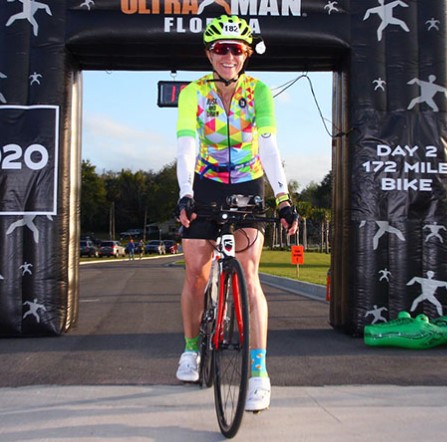 Siobhan Maize sits on her bike at the Ultraman Florida finish line
