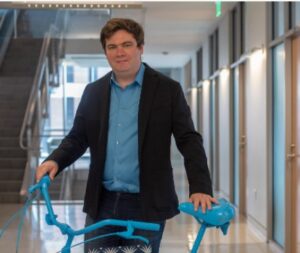 shaun olsen stands with a bike painted blue for lowvelo