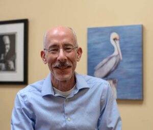 steve rosenzweig stands in art gallery