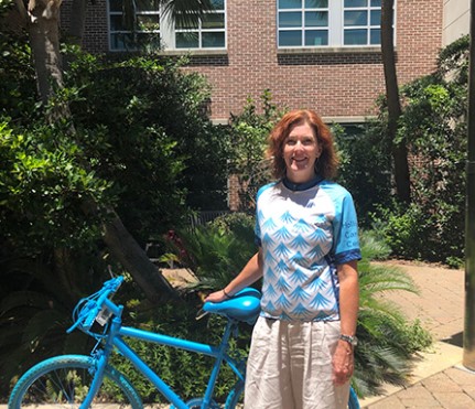 jill simmonds stands next to a bike painted blue for lowvelo