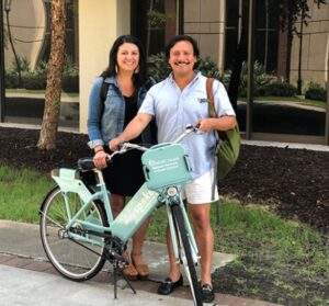 woman and man stand next to a holy spokes bike