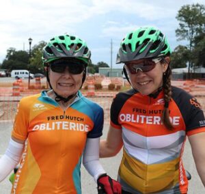 nancy and heather evans stand together with cycling gear on