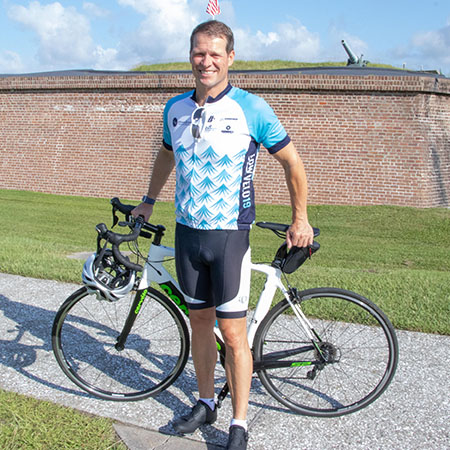Todd Halloran stands with his bike