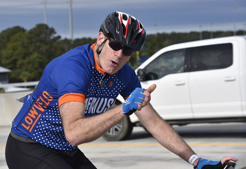 Dr. Denis Guttridge gives a thumbs up while riding in Lowvelo19