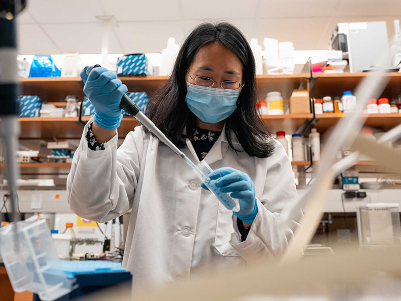 Dr. Jen Wang works with tools in her research lab