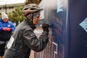 rider writes a message on Why I Ride wall