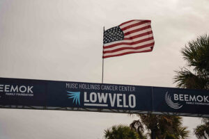 American flag flies at top of starting line truss above Lowvelo logo