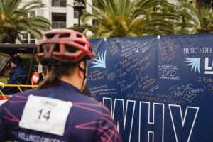rider looks at messages on Why I Ride wall