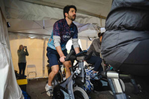 rider on stationary bike in tent