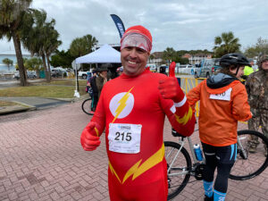 rider in superhero costume gives a thumbs up