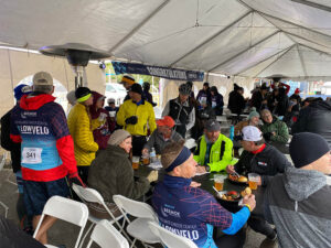 tent full of people eating at finish line party