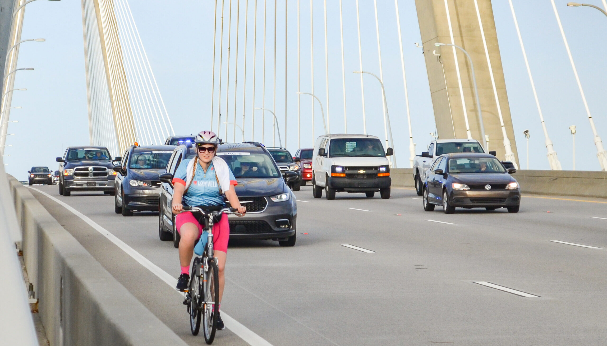 woman riding bikes over Ravenel Bridge