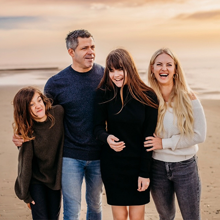 family smiling on beach