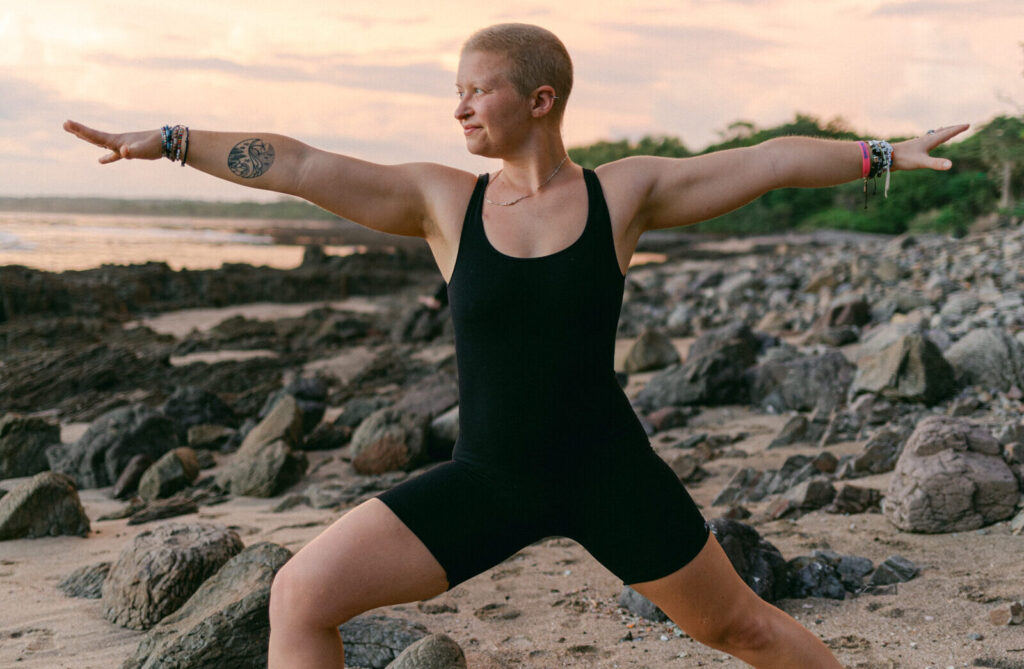 woman doing yoga on beach