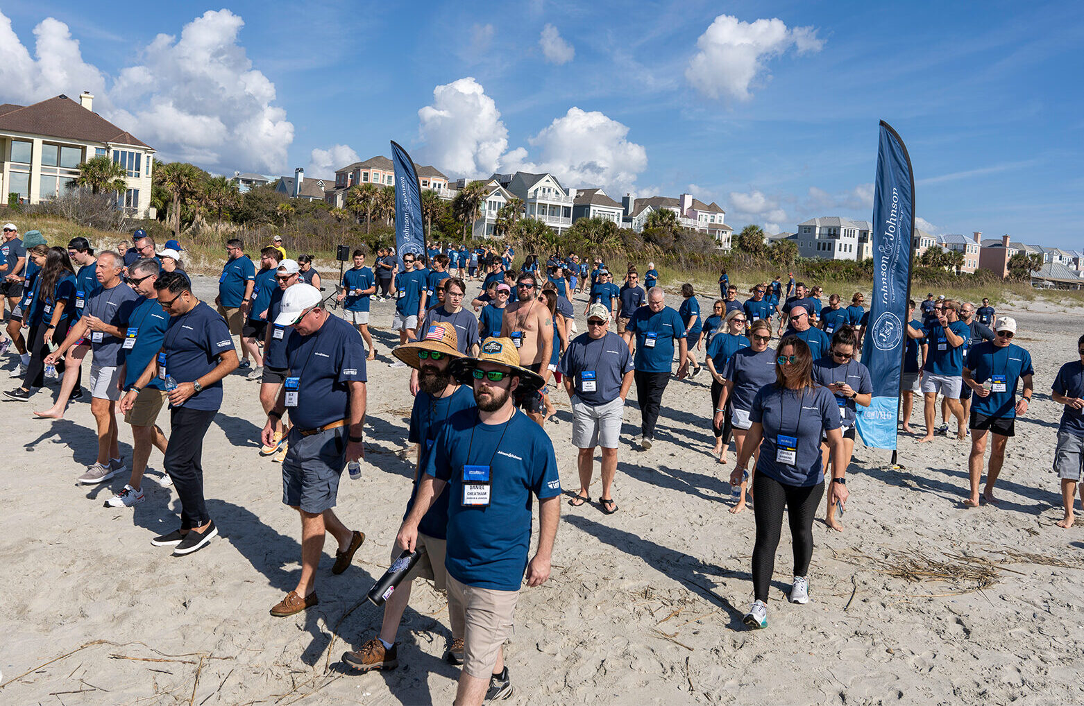 group of people in Lowvelo t shirts walking on the beach
