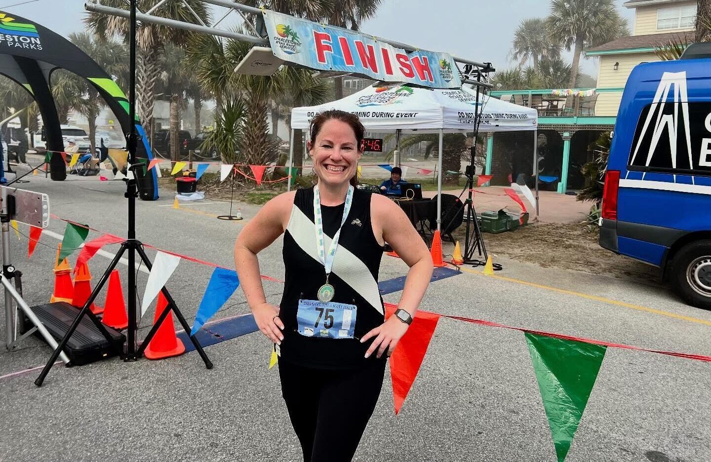 Jennifer Dahne poses at the finish line after completing a half marathon