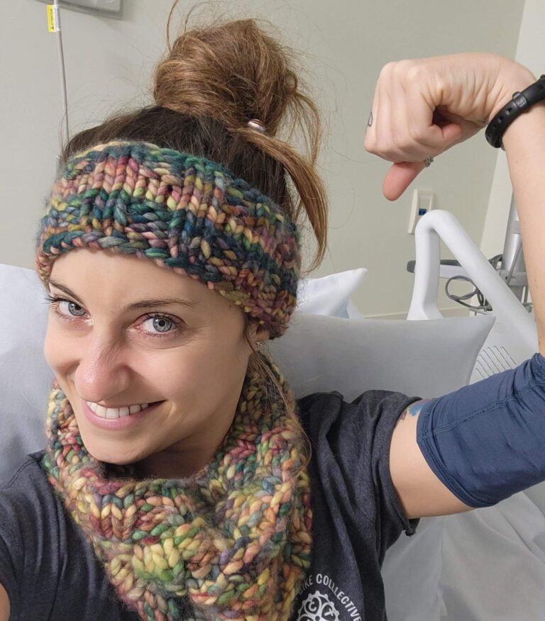 woman in hospital bed flexing bicep