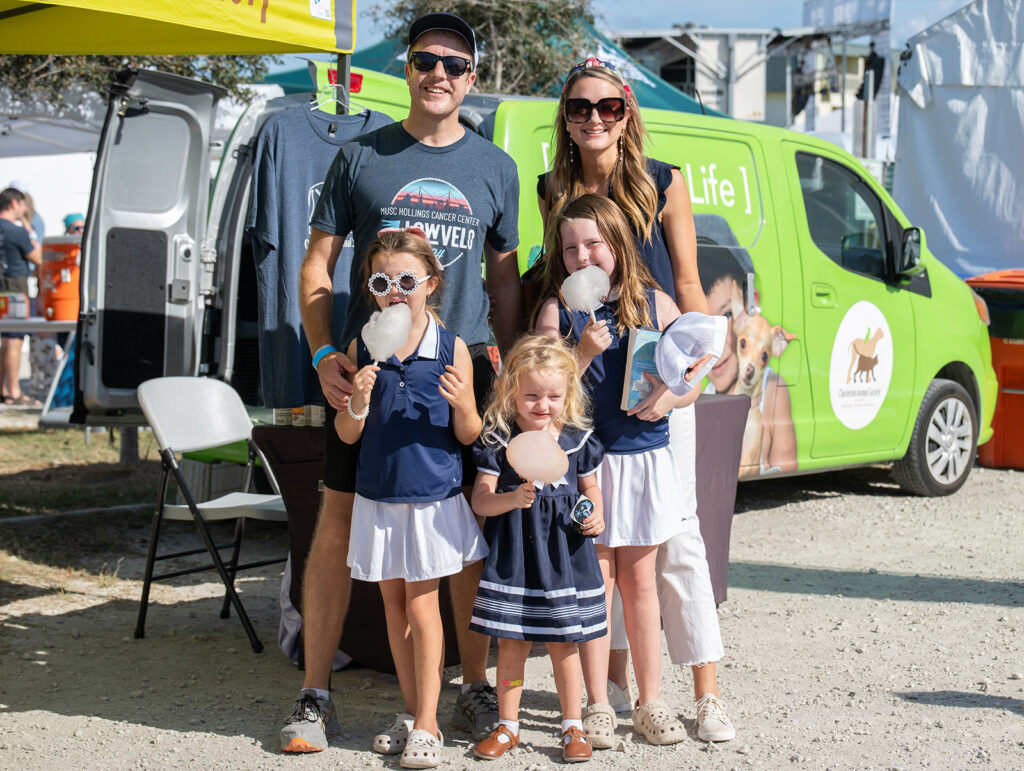 family poses for a photo at the Lowvelo finish line festival