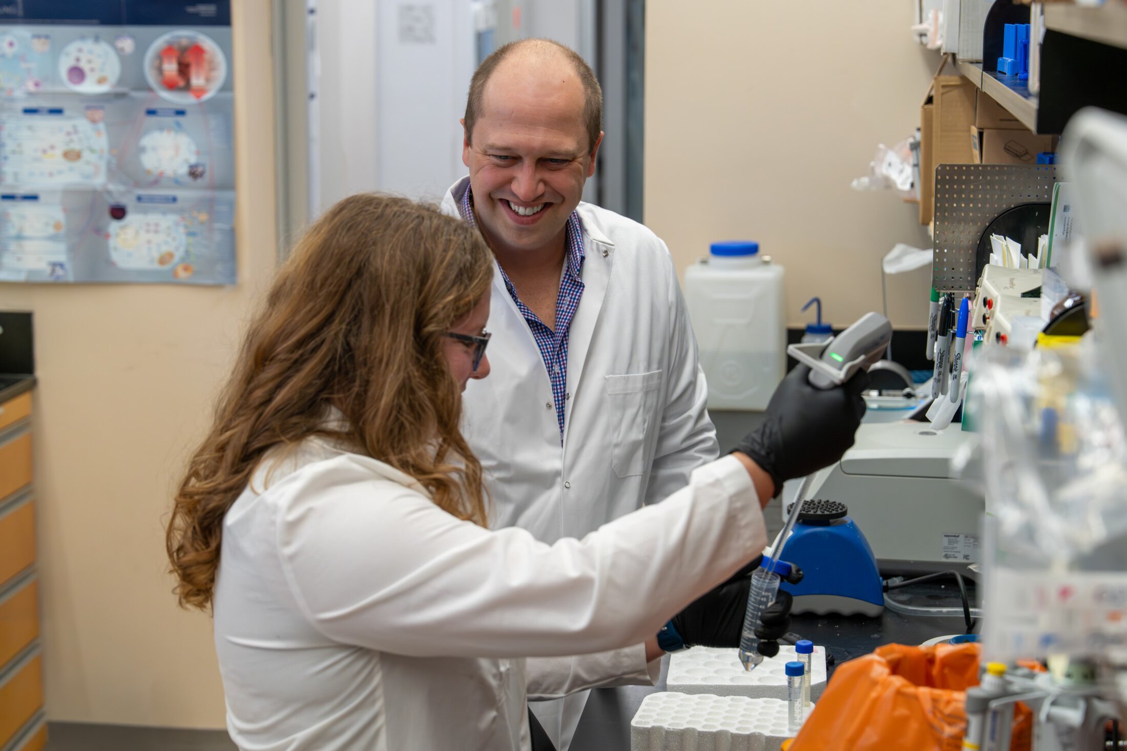 researchers working and smiling in a lab