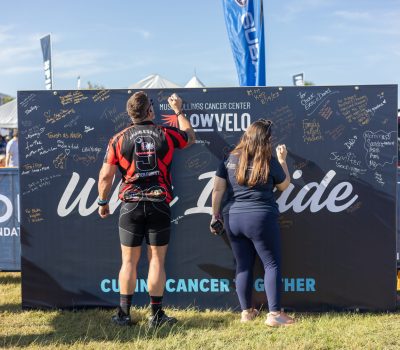 and and woman writing on wall that says why I ride