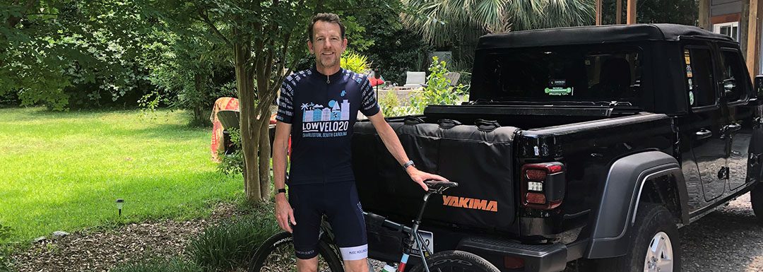 Robert Conley stands with his bike next to his truck