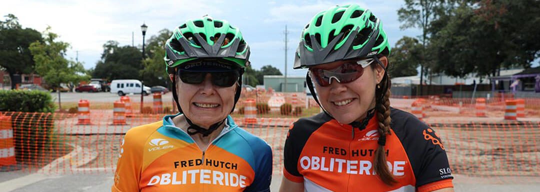 nancy and heather evans stand together with cycling gear on