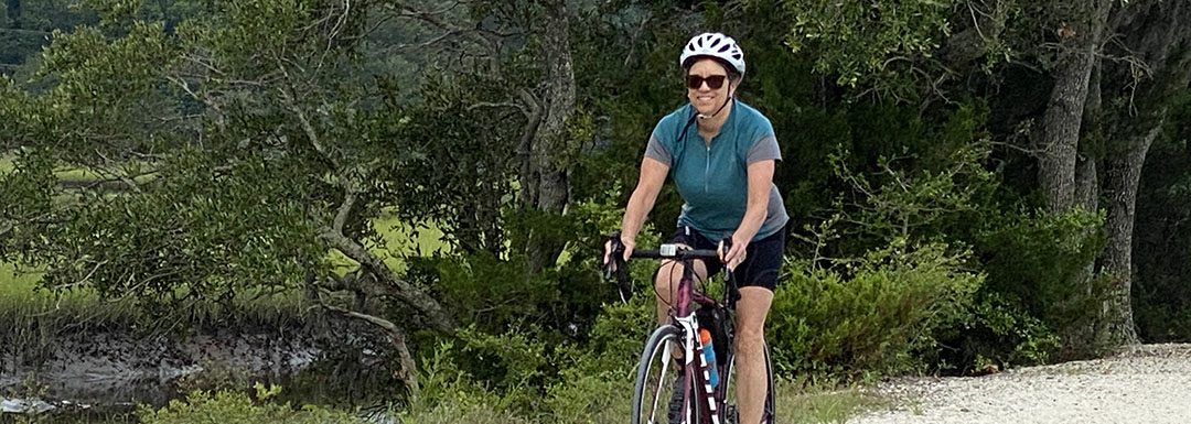 kathy edwards rides her bike on a nature trail